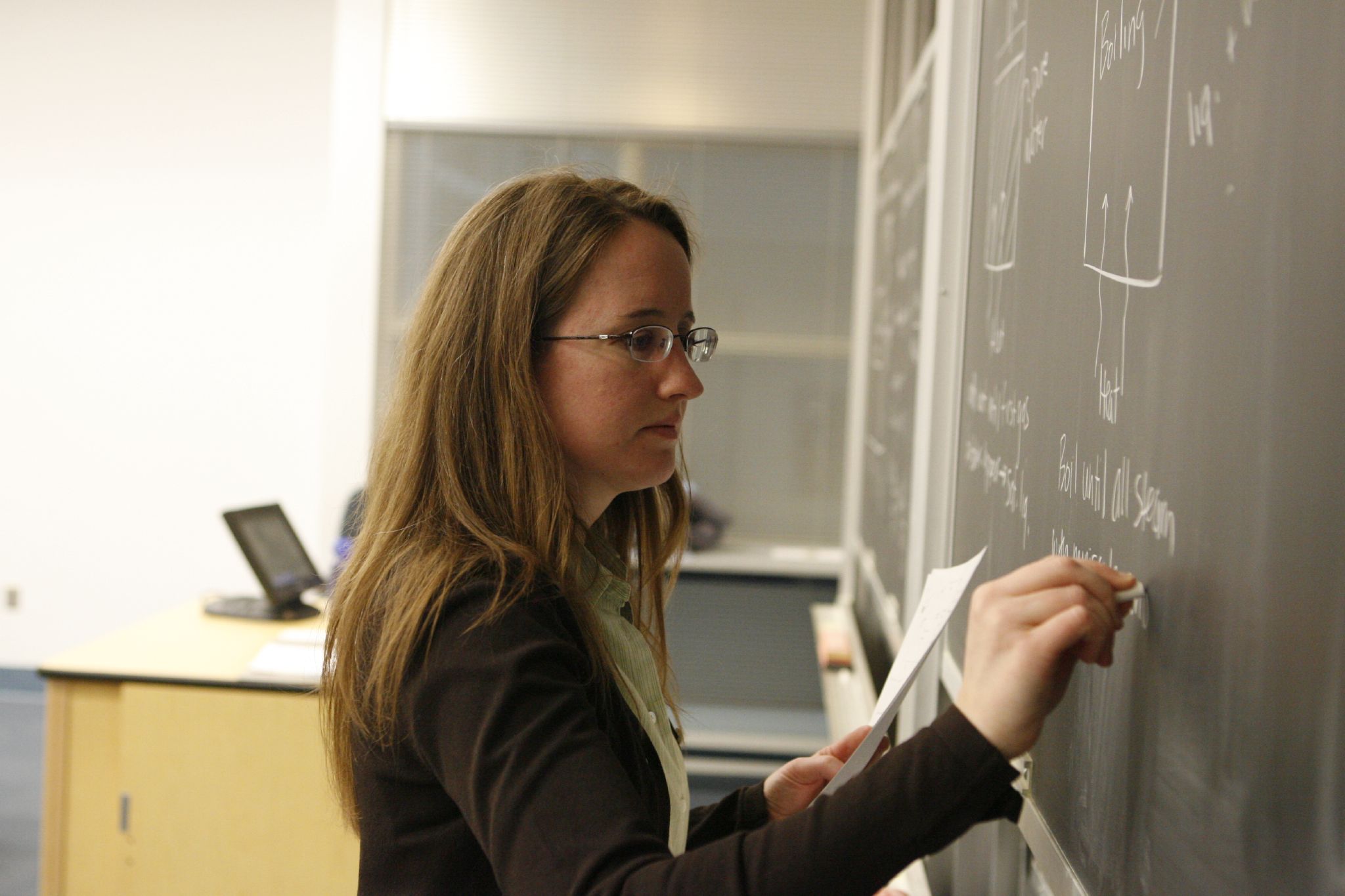 Teacher_writing_on_a_Blackboard Teacher_writing_on_a_Blackboard